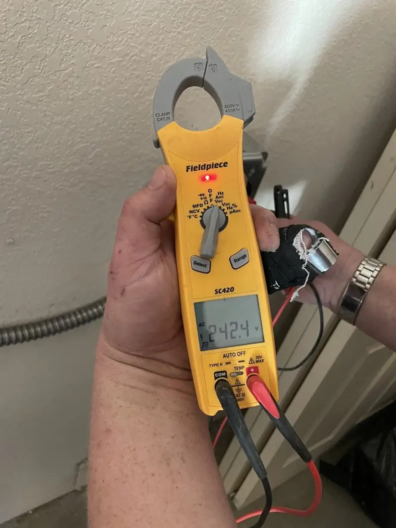 Voltage testing with clamp meter during Ceiling Fan Installation in Cedar Park